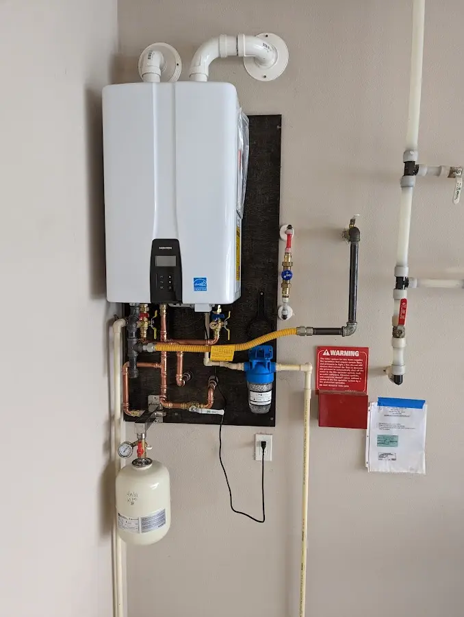 Professional plumber installing copper piping in a Center Line home